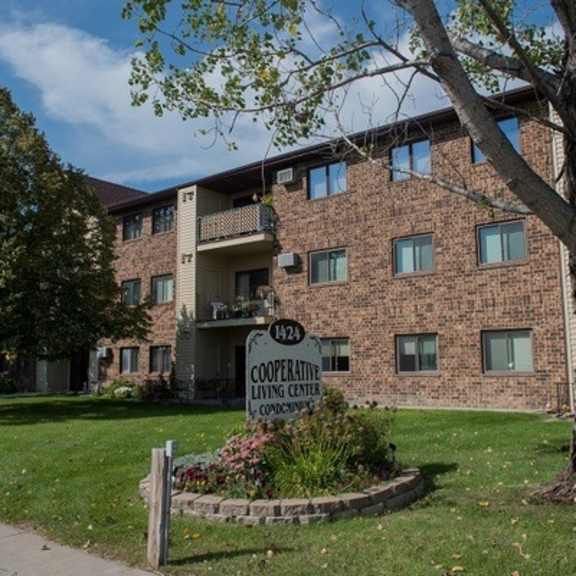 a brick building with a sign that says "cooperative living center".