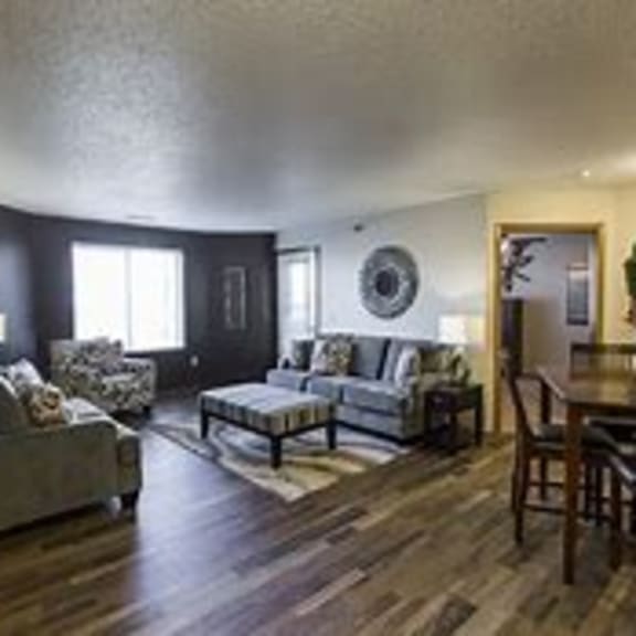 a living room with a couch, chair, and table.