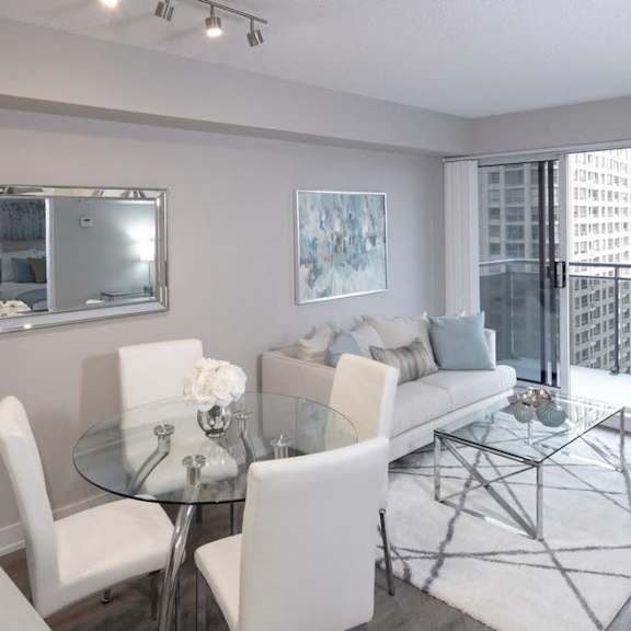a living room with a glass table and a couch