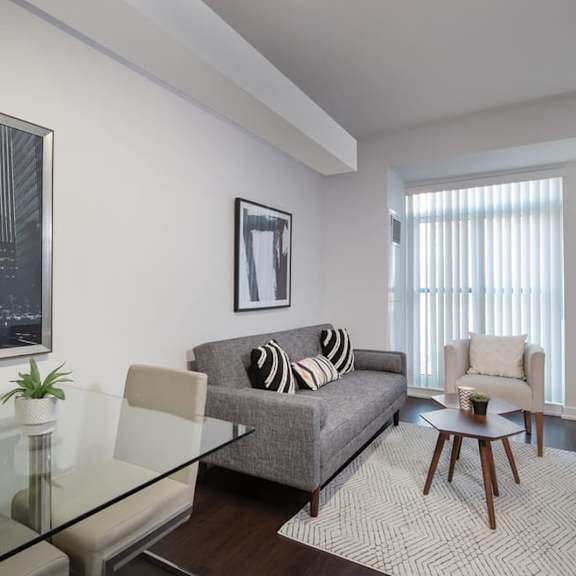 a living room with a couch and a glass table