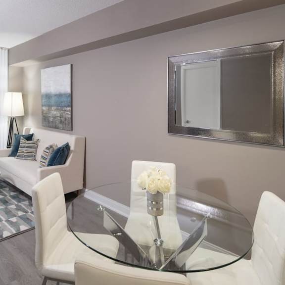 a living room filled with furniture and a large mirror