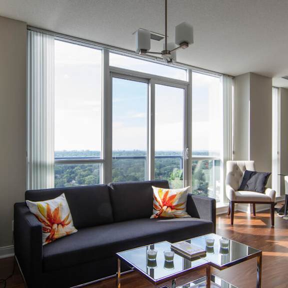 a living room filled with furniture and a large window