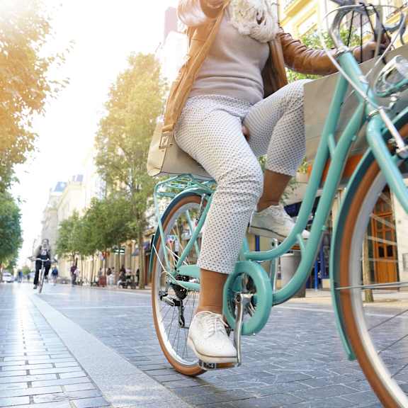 A woman riding a bicycle on a sunny day.