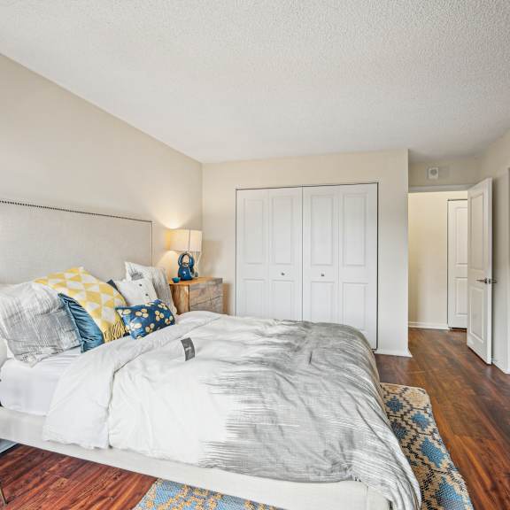 A bedroom with a bed, nightstand, and a lamp.
