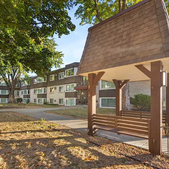 a building with a porch with a bench in front of it