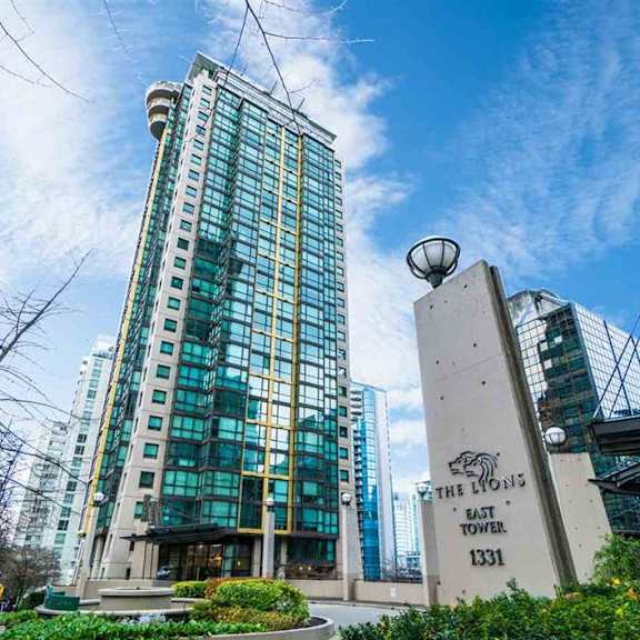 a tall building with a sign in front of it