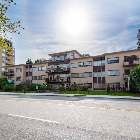 a picture of an apartment building on a sunny day