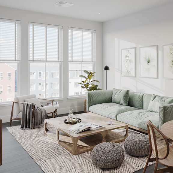 a living room with a green couch and a coffee table