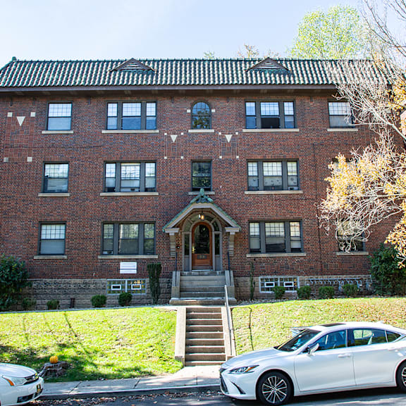 a large brick building with cars parked in front of it