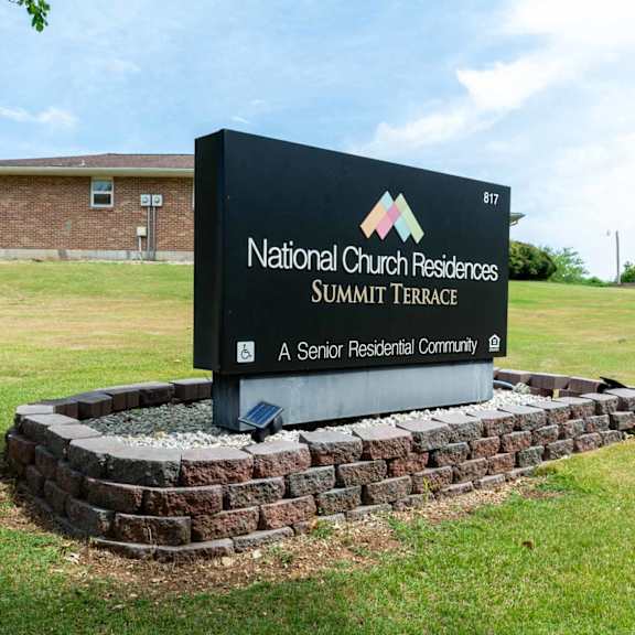 a sign for national church residences summit terrace, a senior residential community.