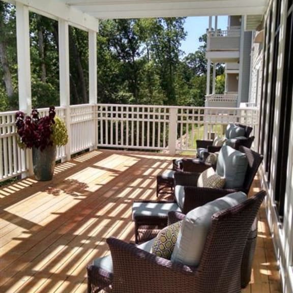 a porch with a bunch of chairs on it