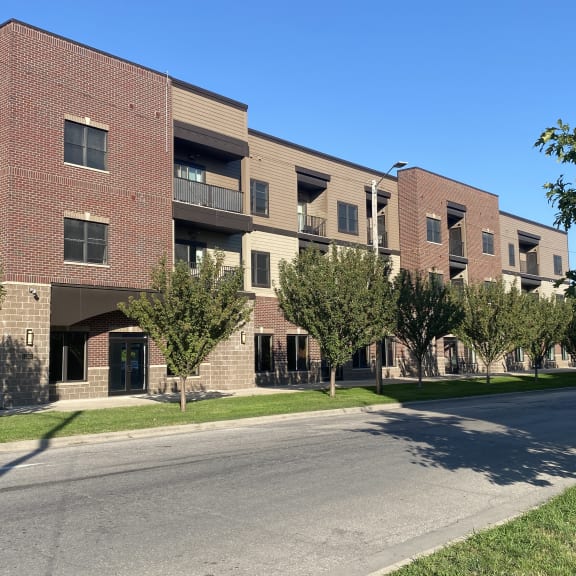 a large brick apartment building with a street in front of it