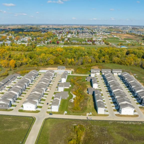 an aerial view of several rows of houses in a parking lot