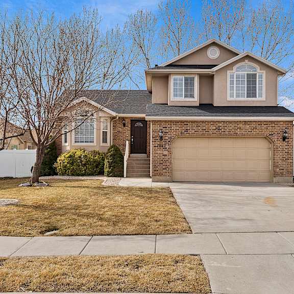 a house with a brown roof and a white garage door.