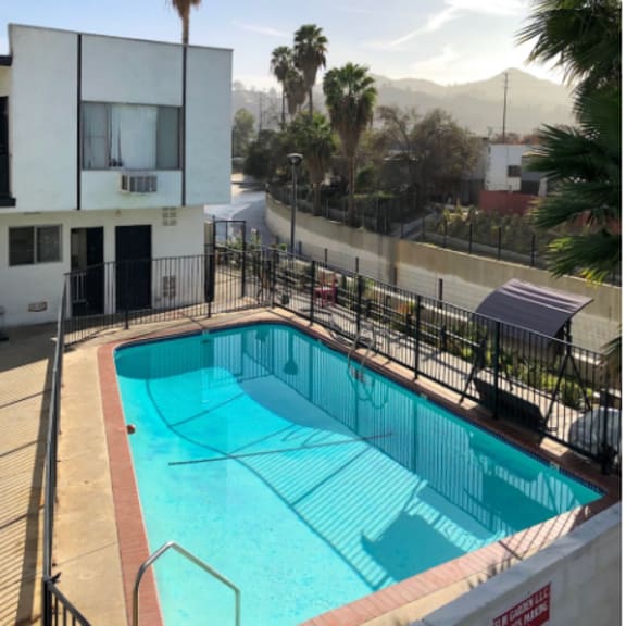 a large swimming pool in front of a building