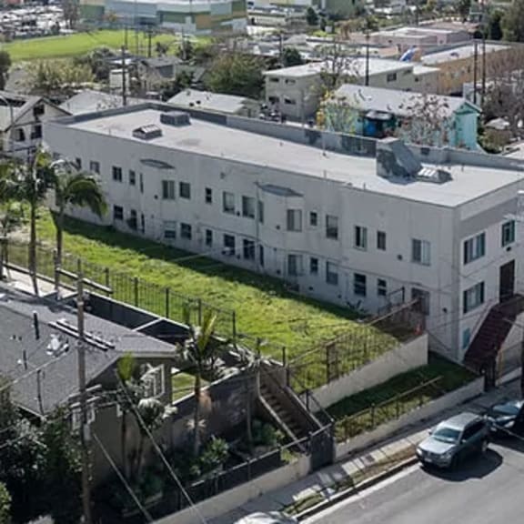 an aerial view of a large white building in a city