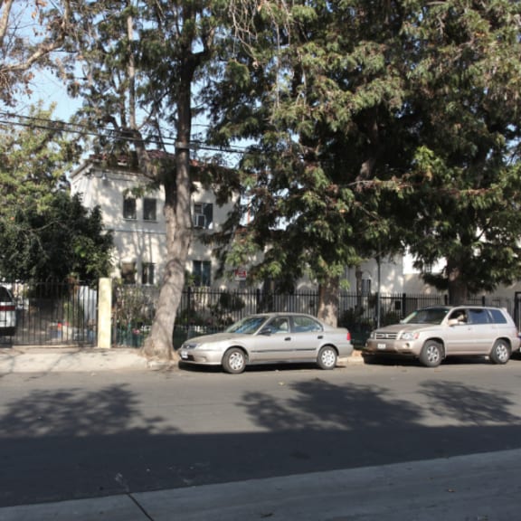 a city street with cars parked in front of a building