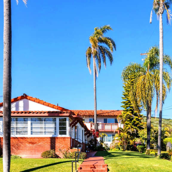 an apartment building with palm trees