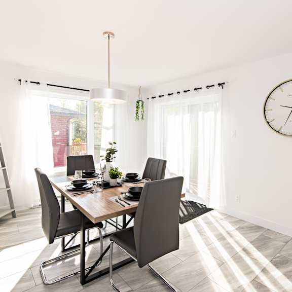 a dining room with a table and chairs.