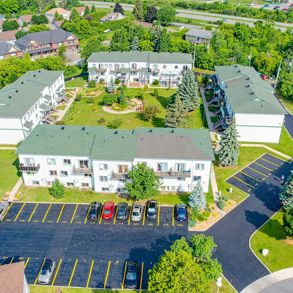 a parking lot with cars and a building in the background.