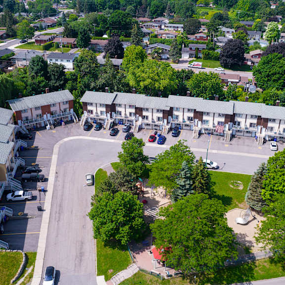 a bird's eye view of a residential area with houses and a park.