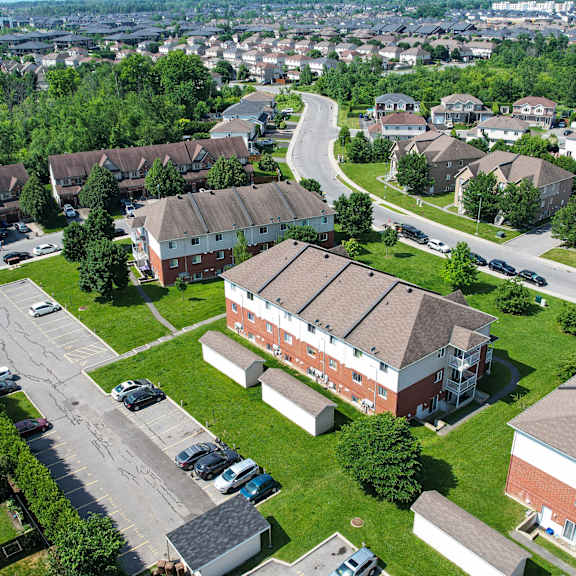 a bird's eye view of a residential area with houses and parked cars.