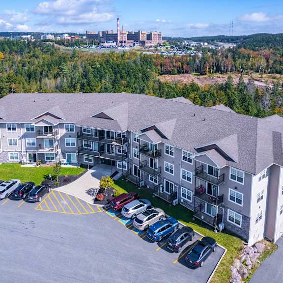 a large building with a parking lot in front of it.