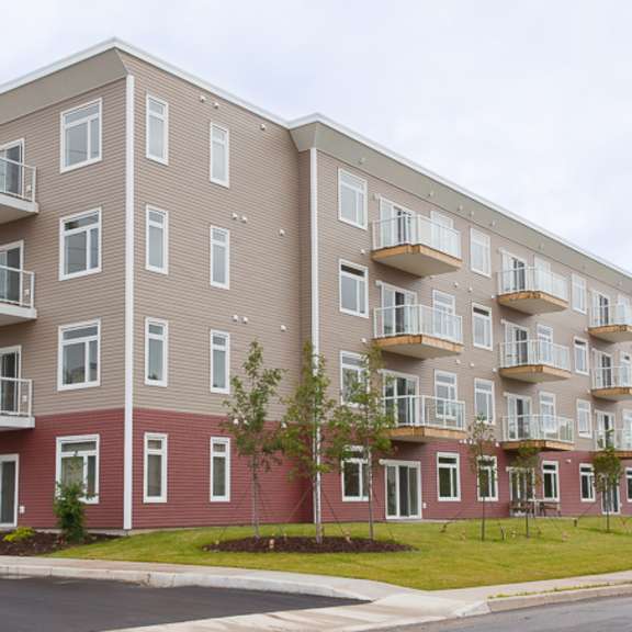 a large apartment building with multiple balconies and windows.