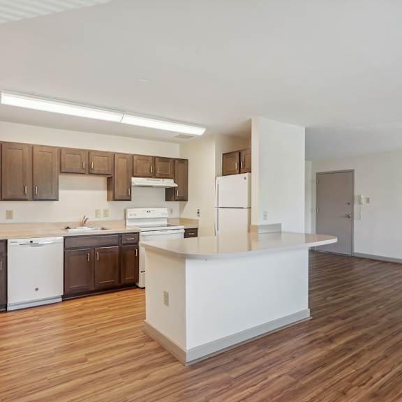 a kitchen with brown cabinets and a white counter.