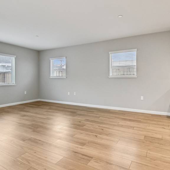 a room with wooden flooring and a fireplace.