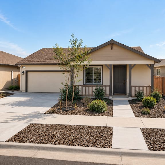 a house with a brown roof and a driveway in front.