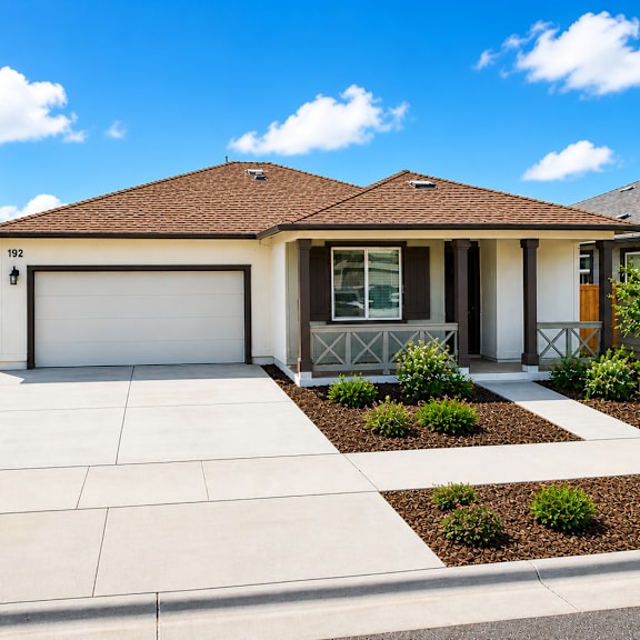 a house with a brown roof and a white garage door.