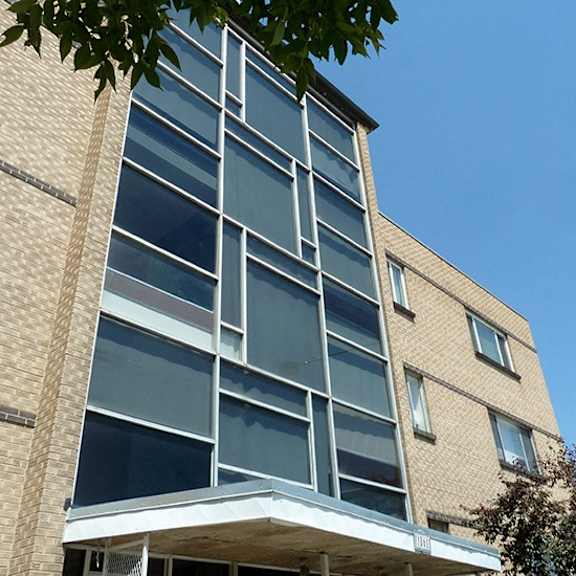 a modern building with a glass facade and a brick exterior.