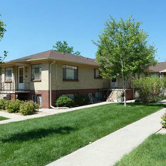 a sunny day at a residential area with houses and green lawns.