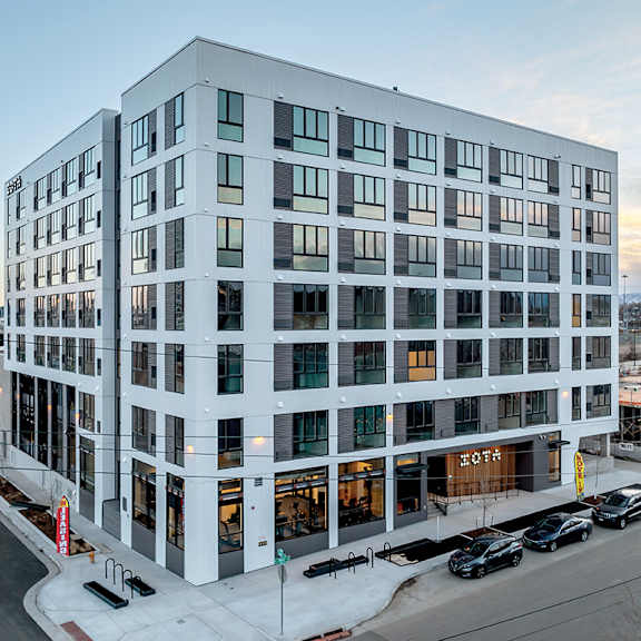 a modern building with a glass facade is shown in the image.