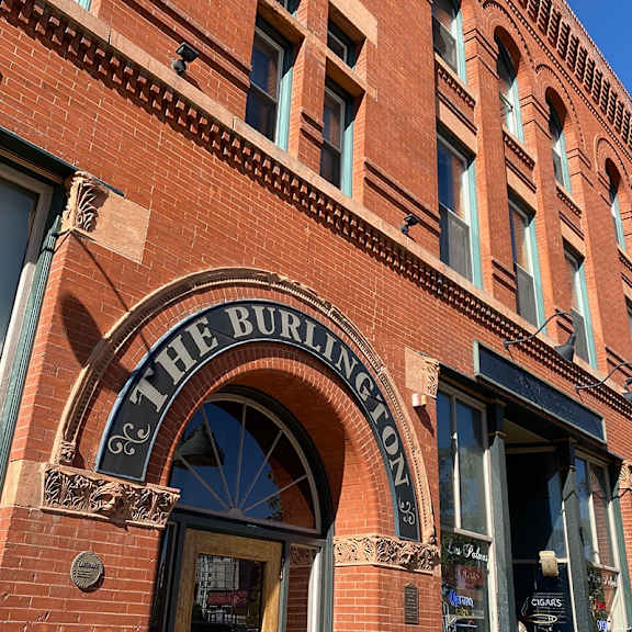 exterior brick facade of the burlington apartments showing  main entry door.