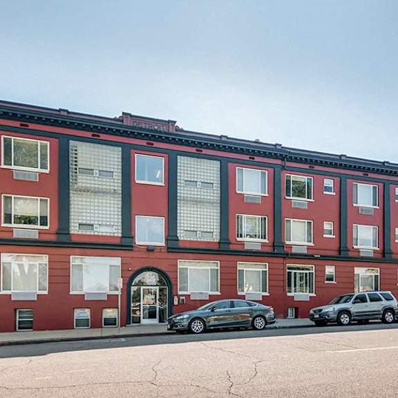 a red building with a black car parked in front.
