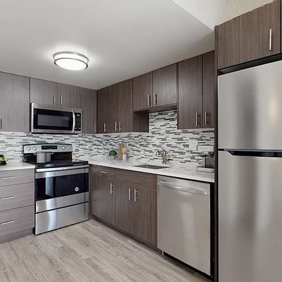 a modern kitchen with a stainless steel refrigerator.