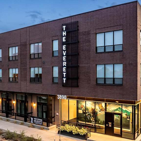 the everett building is a modern structure with a dark facade and large windows.