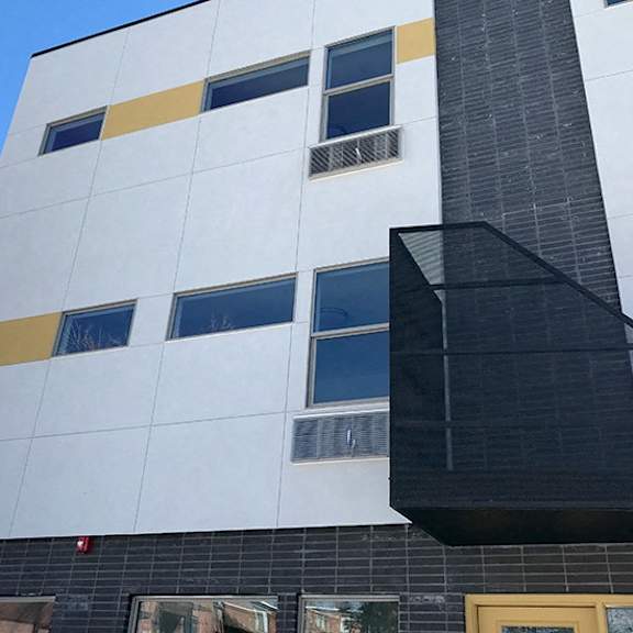 a modern building with a black and white facade and yellow accents.