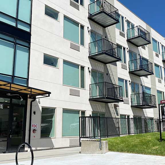 a modern building with a glass facade and balconies.