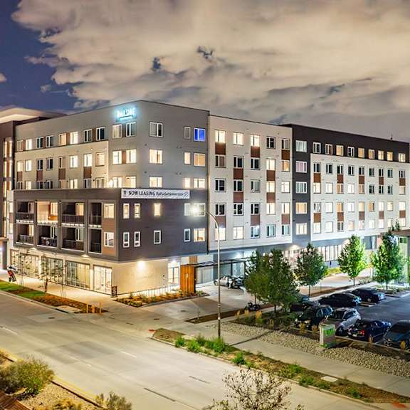 a large building with a parking lot in front of it.