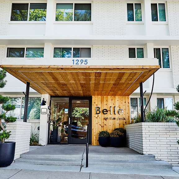the entrance to a building with a wooden canopy and a sign that reads