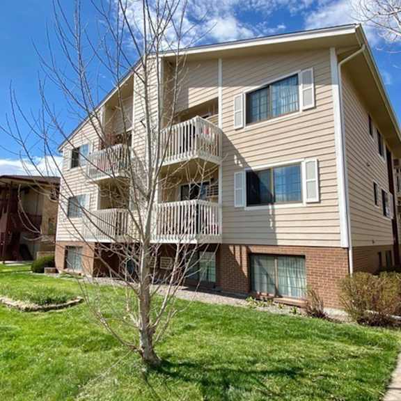 apartment building with a walkway in front.