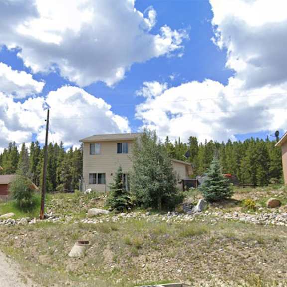 three houses are built on a rocky hillside.
