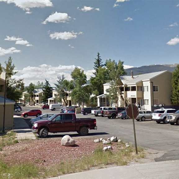 a parking lot with cars and a stop sign.