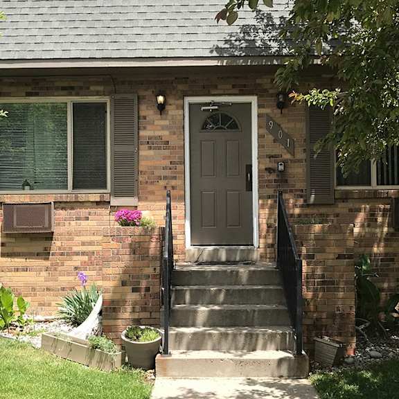 a house with a grey front door and a small garden.