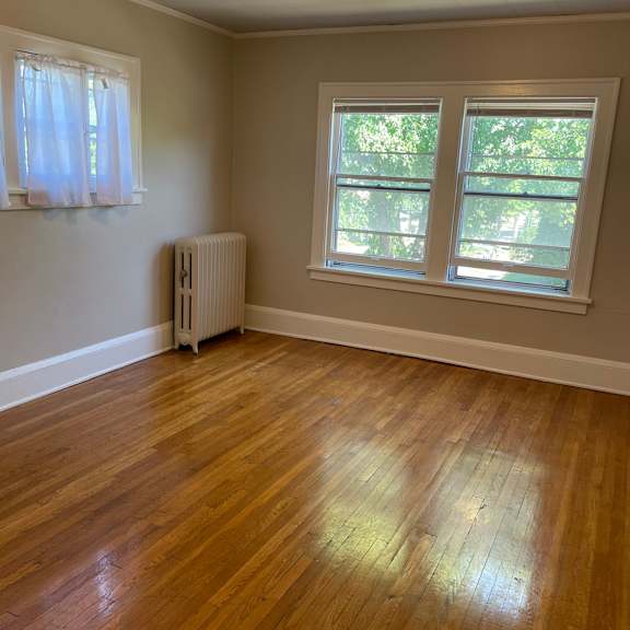 a room with a wooden floor and a window.