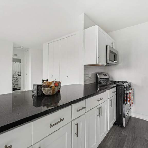 a kitchen with a black countertop at ashlawn at southern towers, virginia