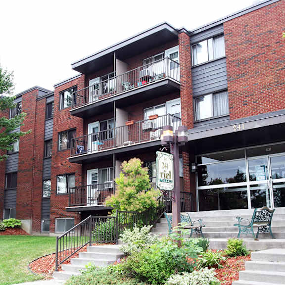 a red brick apartment building with a sign that says "cottage".